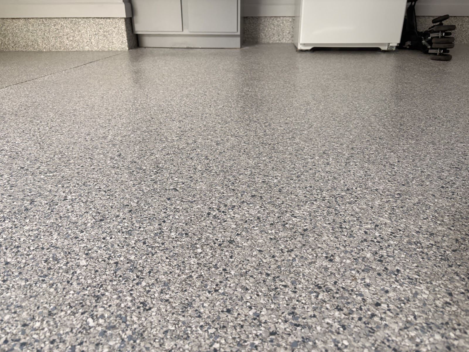 Close-up of decorative flake texture on the team’s completed garage floor
