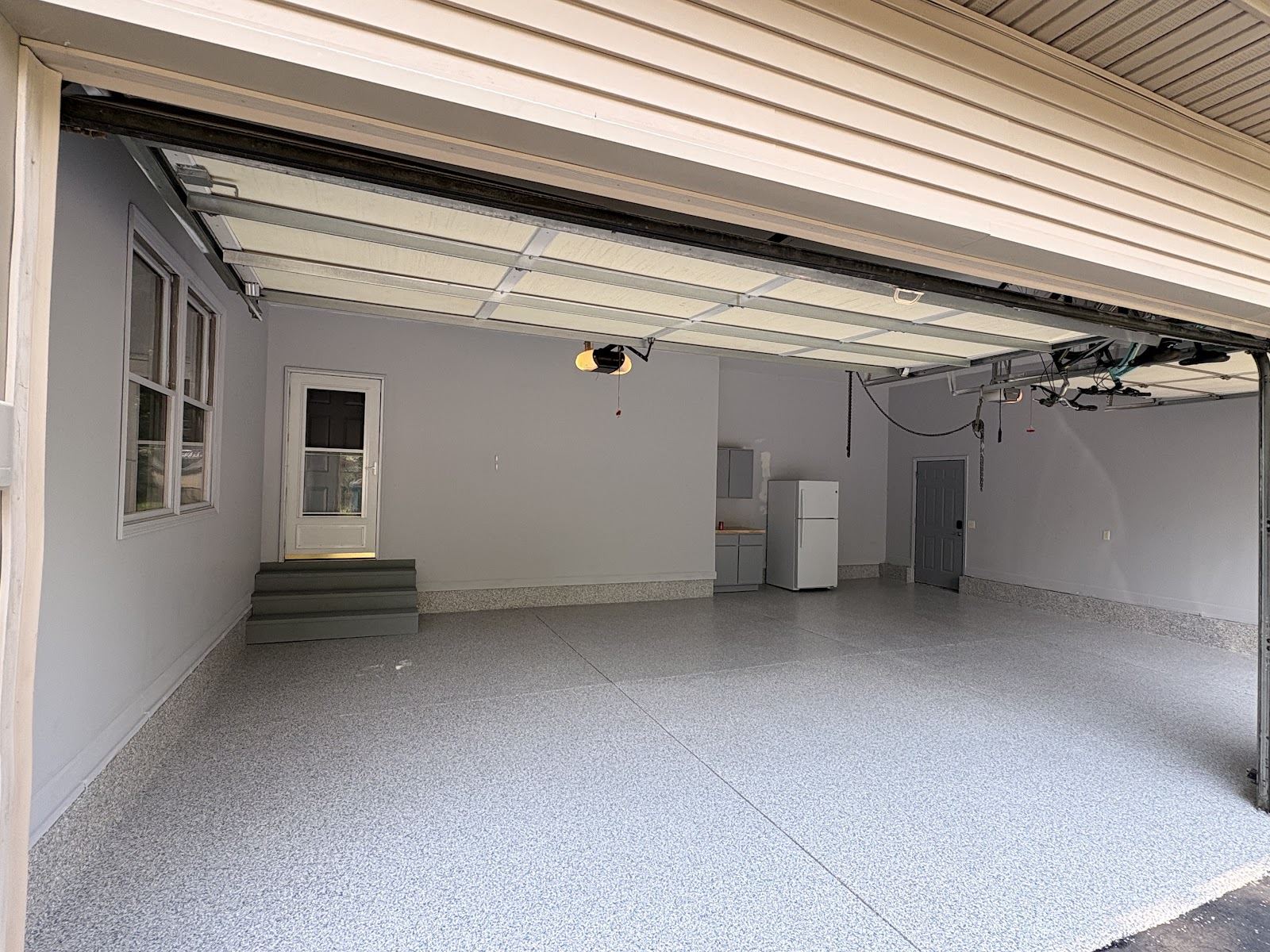 A real House of Epoxy garage project with a finished gray flake floor