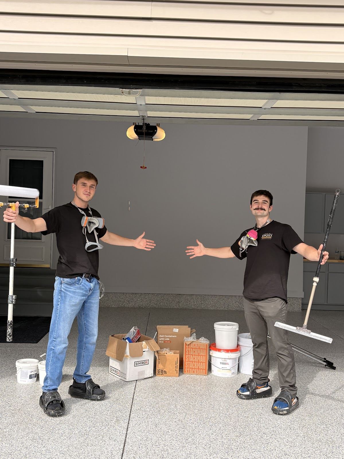The House of Epoxy team on site with coating tools in the completed garage